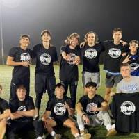 Students wearing championship shirts from a men's flag football tournament